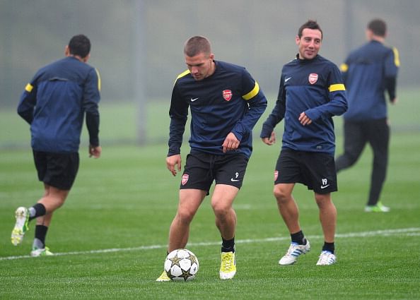 Lukas Podolski (center L) and Santi Cazorla (centre R) of Arsenal take part in a training session ahead of their UEFA Champions League group stage match against Schalke 04 at London Colney on October 23, 2012 in St Albans, England. (Photo by Shaun Botterill/Getty Images)